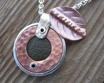 Small Round Sterling and Copper Pendant Inset with Green Leather Including a Copper Leaf