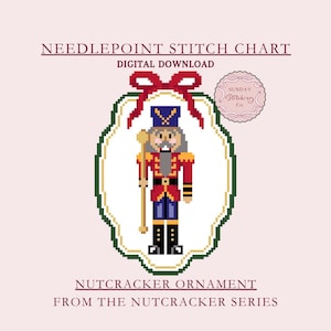 May include: A digital needlepoint stitch chart featuring a pixelated nutcracker ornament design. The nutcracker is dressed in a red coat, blue pants, and a tall blue hat, holding a staff. The design is framed by a green and white border, with a red bow at the top.