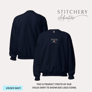 May include: Navy blue unisex sweatshirt with the word "ITALIA" embroidered on the front, along with the Italian flag. The sweatshirt is shown from the front and back. The text "UNISEX NAVY" is at the bottom left. The text "STITCHERY Adventure" is at the top right.