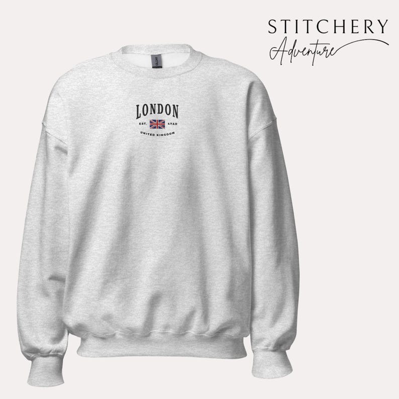 May include: A heather grey sweatshirt with a black graphic on the front that says "LONDON EST. 1968 UNITED KINGDOM" with a small image of the Union Jack flag.