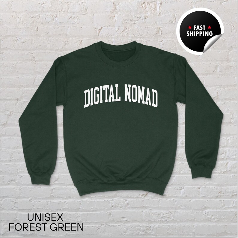 May include: A forest green unisex sweatshirt with the text "DIGITAL NOMAD" in white, arched across the chest. The sweatshirt has long sleeves and a crew neck. The words "UNISEX FOREST GREEN" are printed at the bottom of the image.