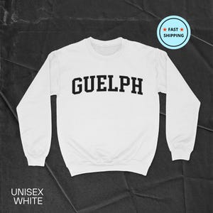 May include: White unisex sweatshirt with black text that reads "GUELPH" in a collegiate font.