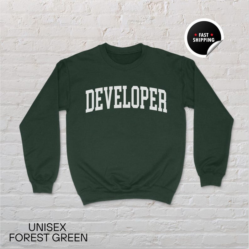 May include: A forest green unisex sweatshirt with the word "DEVELOPER" printed in white block letters. The sweatshirt has long sleeves and a crew neck. The words "UNISEX FOREST GREEN" are printed at the bottom of the image.