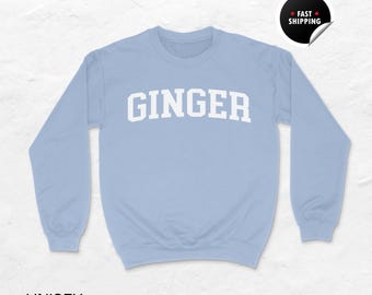 May include: Light blue unisex sweatshirt with the word "GINGER" printed in white on the front.