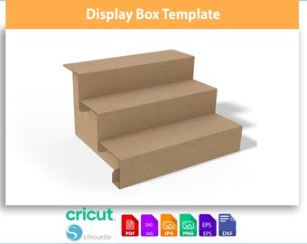 May include: A three-tiered display box template made of brown cardboard. The box has a stepped design, with each level slightly smaller than the one below. The top of the image has the text "Display Box Template". The bottom of the image has the Cricut and Silhouette logos.