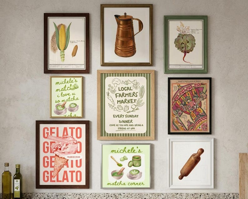 A gallery wall of ten framed botanical and food art prints including a pear, a coffee pot, gelato, and matcha on a light neutral wall.