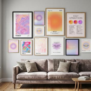 May include: A gallery wall arrangement featuring eleven framed posters with abstract gradients, swirling liquid patterns, and motivational text including Daily Affirmations, Energy, and Angel No. 666, displayed above a velvet sofa.