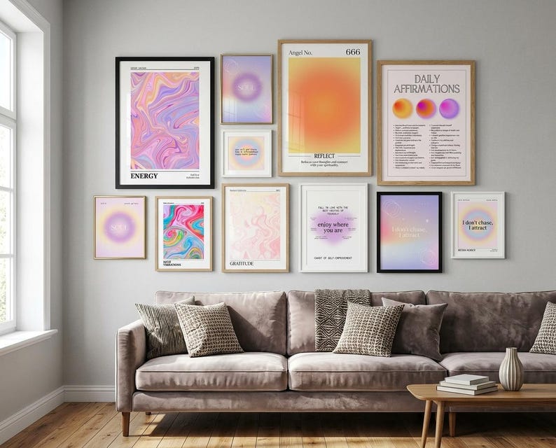 May include: A gallery wall arrangement featuring eleven framed posters with abstract gradients, swirling liquid patterns, and motivational text including Daily Affirmations, Energy, and Angel No. 666, displayed above a velvet sofa.