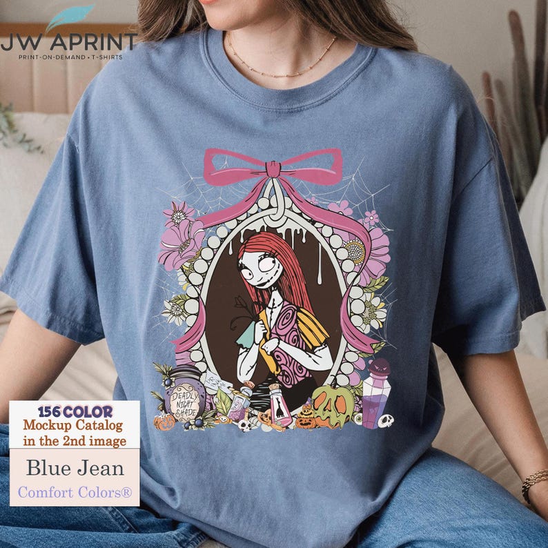 May include: Blue jean Comfort Colors&reg; t-shirt featuring a graphic of Sally from The Nightmare Before Christmas. The design includes a pink bow, floral elements, and the text "DEADLY NIGHT SHADE". The shirt also has the text "156 COLOR Mockup Catalog in the 2nd image".