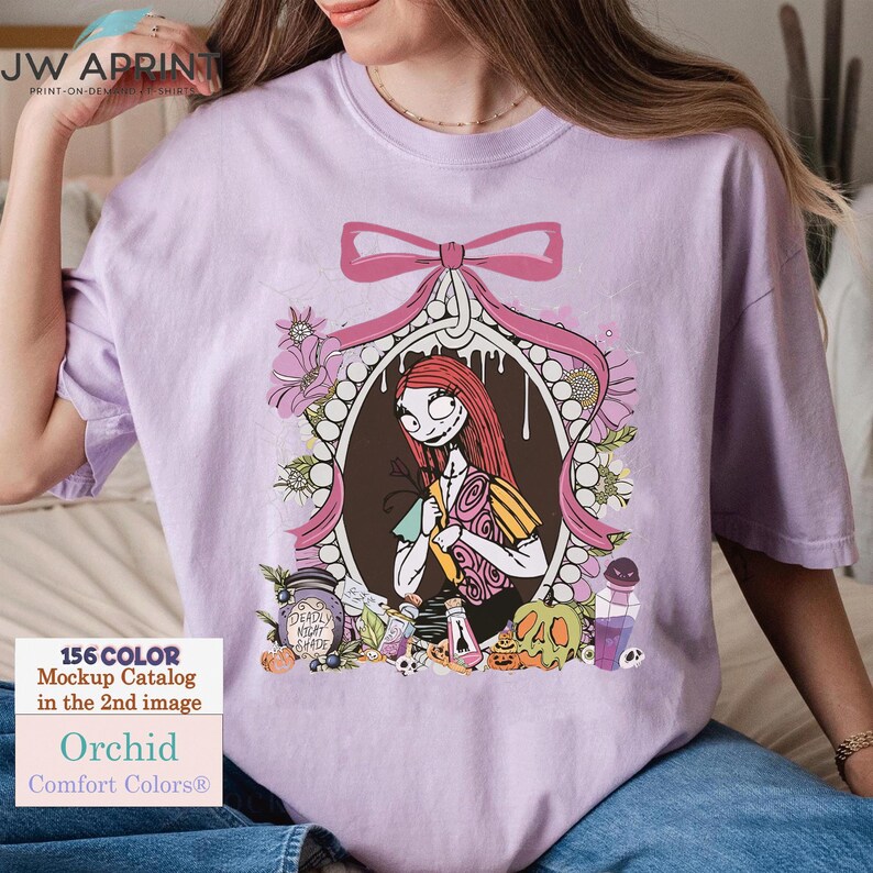 May include: Orchid Comfort Colors t-shirt featuring a framed illustration of Sally from The Nightmare Before Christmas. The design includes a pink bow, flowers, and Halloween-themed elements. The shirt also has the text "156 COLOR Mockup Catalog in the 2nd image".