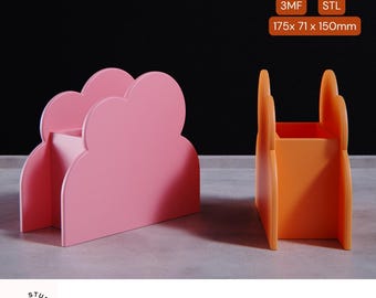 May include: Two desk organizers, one shaped like a cloud in pink and the other a rectangular shape in orange. The cloud organizer is 175 x 71 x 150mm.