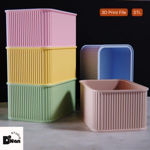 Puede incluir: Varios contenedores de almacenamiento rectangulares en colores pastel. Tres cajas apiladas en rosa, amarillo y verde, con detalles verticales acanalados. También se muestra un contenedor rosa claro y un contenedor azul. La imagen incluye el texto "3D Print File STL".