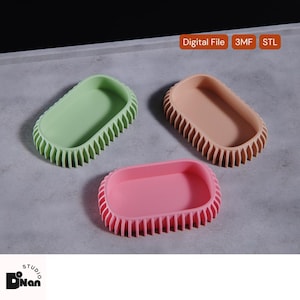 May include: Three oval-shaped trays in pastel colors: green, peach, and pink. Each tray has a ridged border and a smooth interior. The image also includes the text "Digital File 3MF STL".
