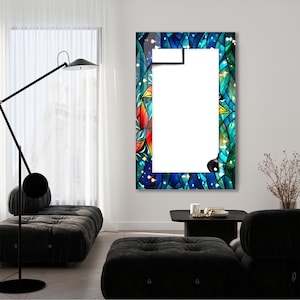 May include: A rectangular mirror with a colorful stained glass frame. The frame features a blue, green, and red floral design with gold accents. The mirror is hanging on a white wall.