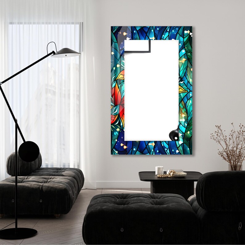 May include: A rectangular mirror with a colorful stained glass frame. The frame features a blue, green, and red floral design with gold accents. The mirror is hanging on a white wall.