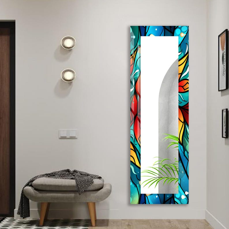May include: A full-length mirror with a colorful, abstract design in shades of blue, yellow, red, and orange. The mirror is framed in a blue border.