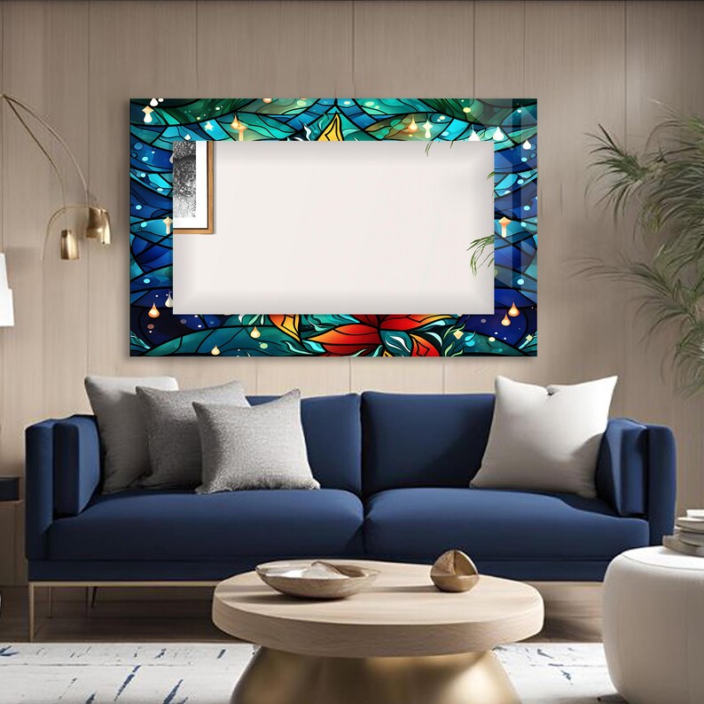 May include: A blue velvet sofa with two pillows sits in front of a large, colorful framed mirror. The mirror has a stained glass design with blue, green, yellow, and red colors. The mirror is hanging on a light brown wall.