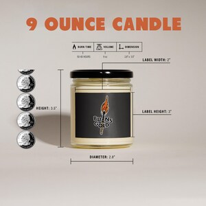 May include: A 9 ounce candle in a clear glass jar with a black lid. The candle has a black label with the text "BURNS GOLD" and a graphic of a burning torch. The jar is 3.5 inches tall and 2.8 inches in diameter. The label is 2 inches wide and 3 inches tall. The candle has a burn time of 50-60 hours.