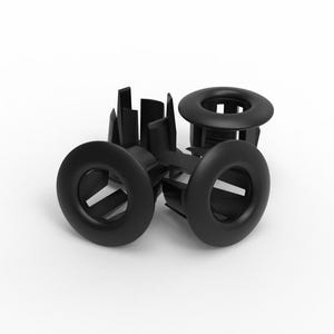 May include: A collection of black plastic grommets. Each grommet has a circular outer ring and a central opening. The grommets are designed with a series of supporting structures. The objects are arranged against a white background.