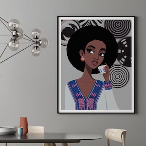 May include: A framed art print featuring a stylized illustration of a woman with dark skin and an afro, holding a teacup. The woman wears a white top with blue and pink patterned details. Decorative black and white circular wall art is in the background.