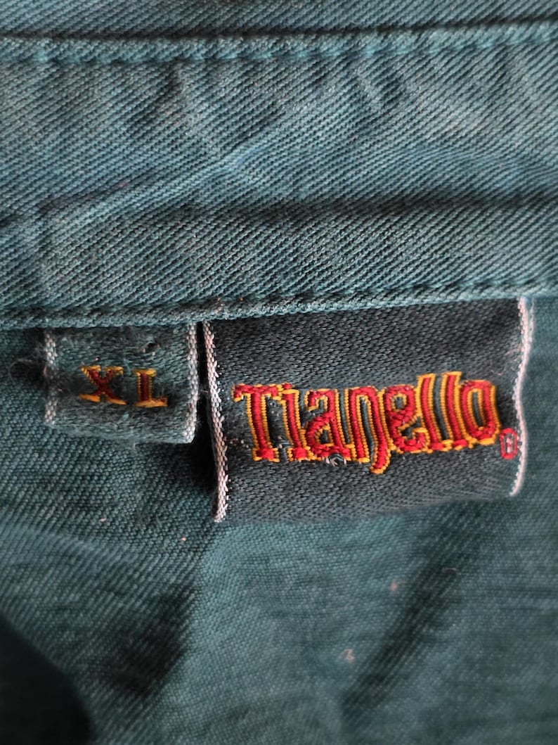 May include: A set of three ceramic mugs with a speckled, matte finish. Each mug features a different color: light blue, cream, and gray. The mugs have a simple, modern design with a rounded shape and a comfortable handle.