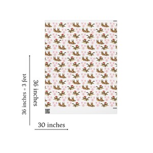 May include: A white blanket with a repeating pattern of brown dogs wearing Santa hats and red snowflakes. The blanket measures 30 inches wide and 36 inches long.