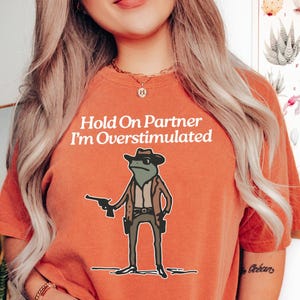 Hold On Partner I&#39;m Overstimulated - Funny Shirts, Gift Shirts, Stimulated, Overstimulated, Funny Frog, Trendy Tee, Meme Shirt, Unisex Shirt