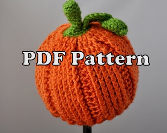 May include: A crocheted pumpkin hat in orange with green leaves. The hat is on a black stand and the text "PDF Pattern" is visible in the image.