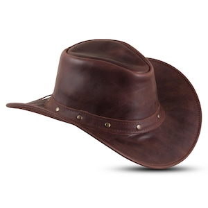 May include: A brown leather cowboy hat with a wide brim and a studded band.