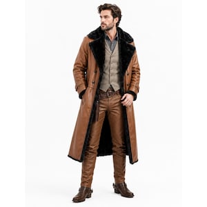 May include: A long tan leather trench coat with a black faux fur lining and collar, worn over a beige button-up vest, a dark gray collared shirt, and matching tan leather trousers. The outfit includes a brown leather belt and brown leather boots.