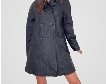May include: A black double-breasted coat with a classic design. The coat features a notched collar, two rows of buttons, and two front pockets. The coat is knee-length and has a slightly flared skirt.