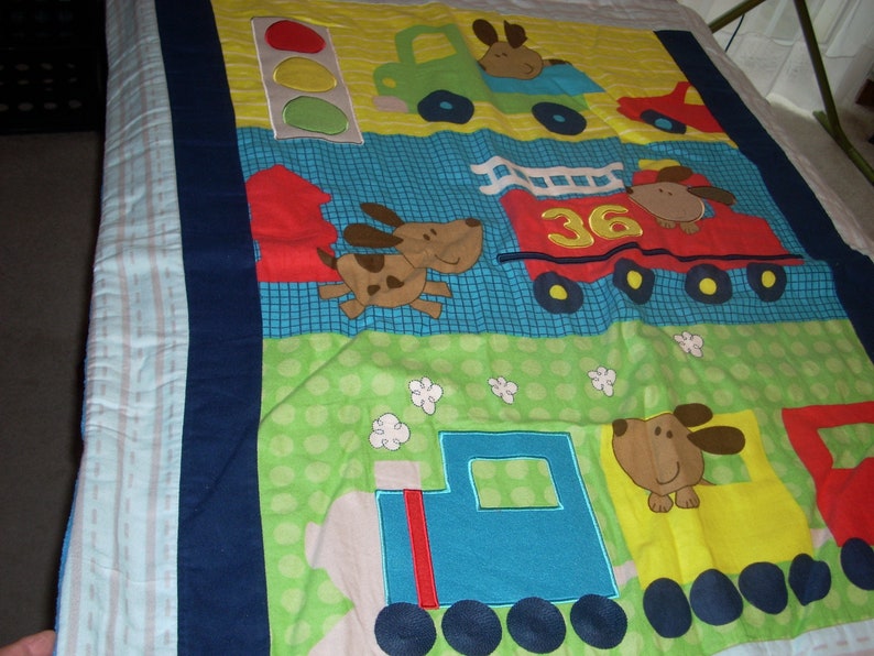 by 34 inches wide 40 inches long Firetruck and Train cotton front and blue fleece backing small size Blanket Puppy in Truck