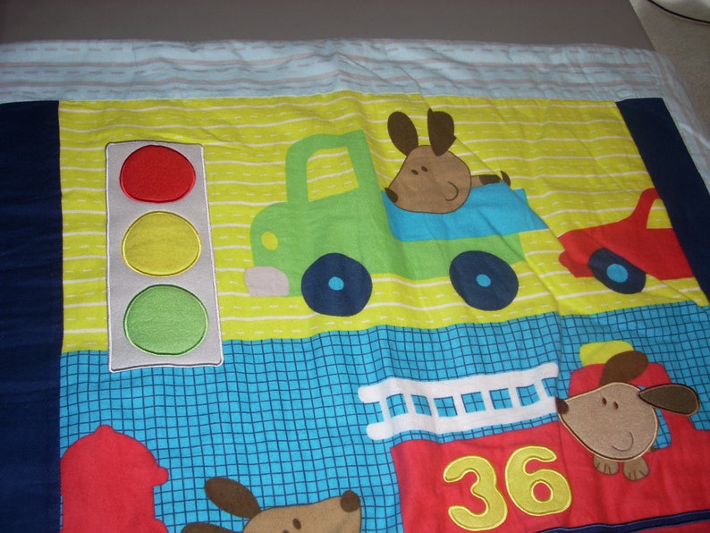 by 34 inches wide 40 inches long Firetruck and Train cotton front and blue fleece backing small size Blanket Puppy in Truck