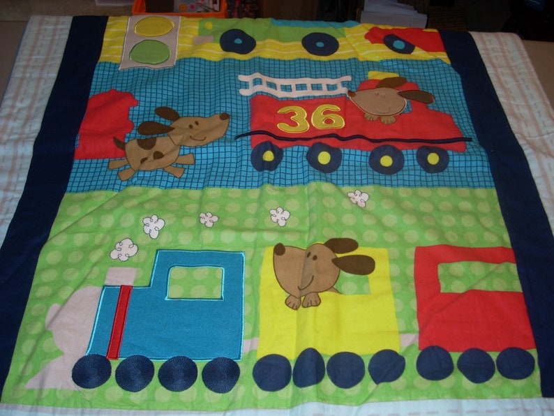 by 34 inches wide 40 inches long Firetruck and Train cotton front and blue fleece backing small size Blanket Puppy in Truck