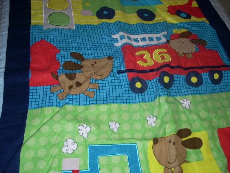 by 34 inches wide 40 inches long Firetruck and Train cotton front and blue fleece backing small size Blanket Puppy in Truck