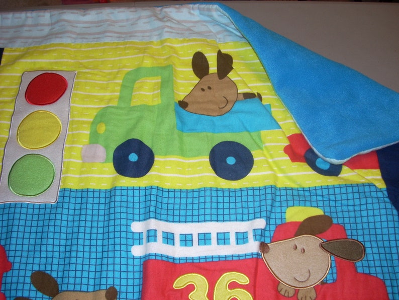 by 34 inches wide 40 inches long Firetruck and Train cotton front and blue fleece backing small size Blanket Puppy in Truck