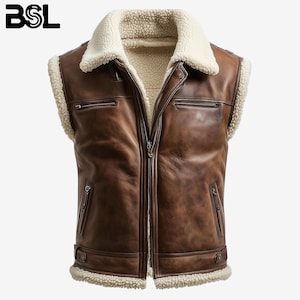 May include: Brown leather vest with a cream-colored shearling collar and lining. The vest has a zip-up front, two zippered chest pockets, and two side pockets. The BSL logo is visible in the upper left corner. The vest is sleeveless.
