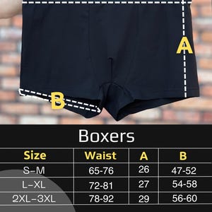 May include: Black boxer briefs with a size chart overlay. The image displays the garment with dashed lines labelled Waist, A, and B. A table below lists sizes S-M, L-XL, and 2XL-3XL with corresponding measurements in centimetres for Waist, A, and B.