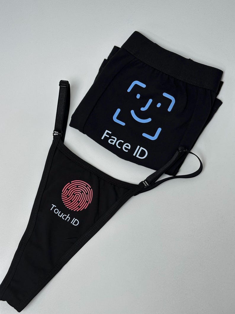 May include: A black thong and a black pair of boxer briefs. The thong features a pink fingerprint graphic with the text "Touch ID" below it. The boxer briefs feature a light blue facial recognition frame graphic with the text "Face ID" below it.