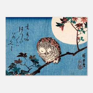 May include: A Japanese woodblock print featuring a brown and white owl perched on a tree branch against a large full moon and a blue background. The artwork includes red and green maple leaves, black Japanese calligraphy, and a red artist seal.