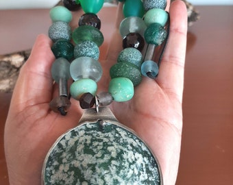 Modern look hand made necklace with old green bluish glass beads and a Roman glass pendant set in oxidized sterling silver. tribalgallery.
