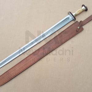 May include: A silver sword with a brown leather scabbard. The sword has a decorative handle with a white bone-like material. The scabbard has a brown leather strap.