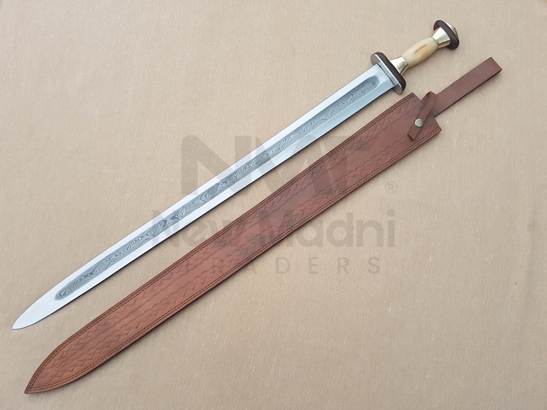 May include: A silver sword with a brown leather scabbard. The sword has a decorative handle with a white bone-like material. The scabbard has a brown leather strap.