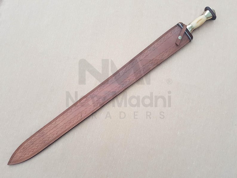 May include: A brown leather scabbard with a decorative pattern. The scabbard is for a sword with a brass handle and a black blade.