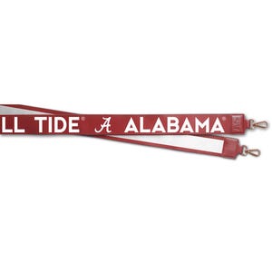 May include: A red and white shoulder strap with the text "ALABAMA" and "TIDE" in white. The strap has gold-colored metal clasps on each end. The strap is designed for a bag or purse.