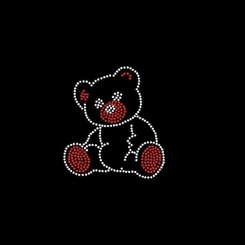 May include: A black graphic of a teddy bear made of white and red rhinestones. The bear is outlined in white rhinestones, with red rhinestones filling in the ears, nose, and paws. The background is solid black.