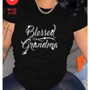 May include: Black t-shirt with the text "Blessed Grandma" in a rhinestone design. The shirt has a round neck and short sleeves. The image also includes the measurements W=11 and L=10.