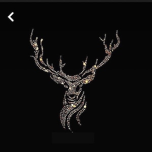 May include: A stag head silhouette composed of numerous small, glowing dots against a black background. The antlers are prominent, and the overall design is symmetrical. The dots create a sparkling effect, suggesting a festive or decorative item.