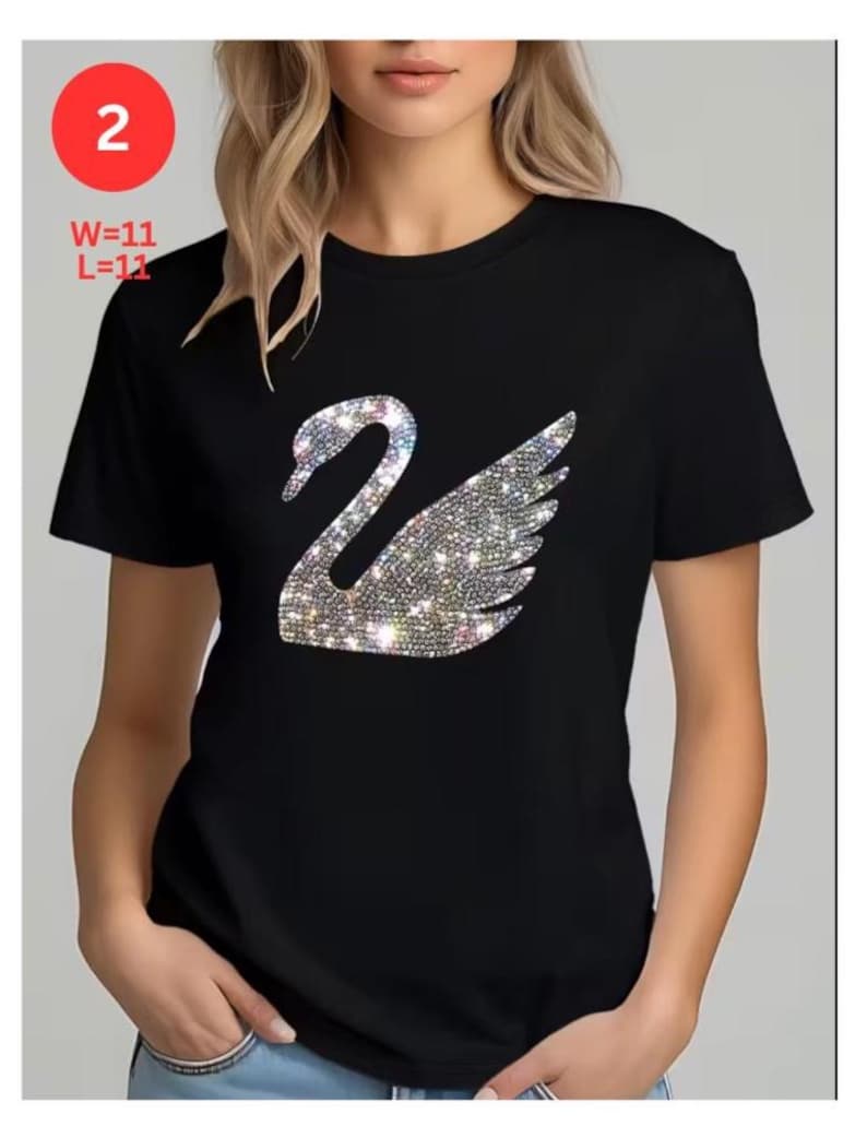 May include: Black t-shirt featuring a sparkling swan design. The swan is made of iridescent rhinestones. The text "2" is in a red circle in the upper left corner. The text "W=11 L=11" is below the red circle.