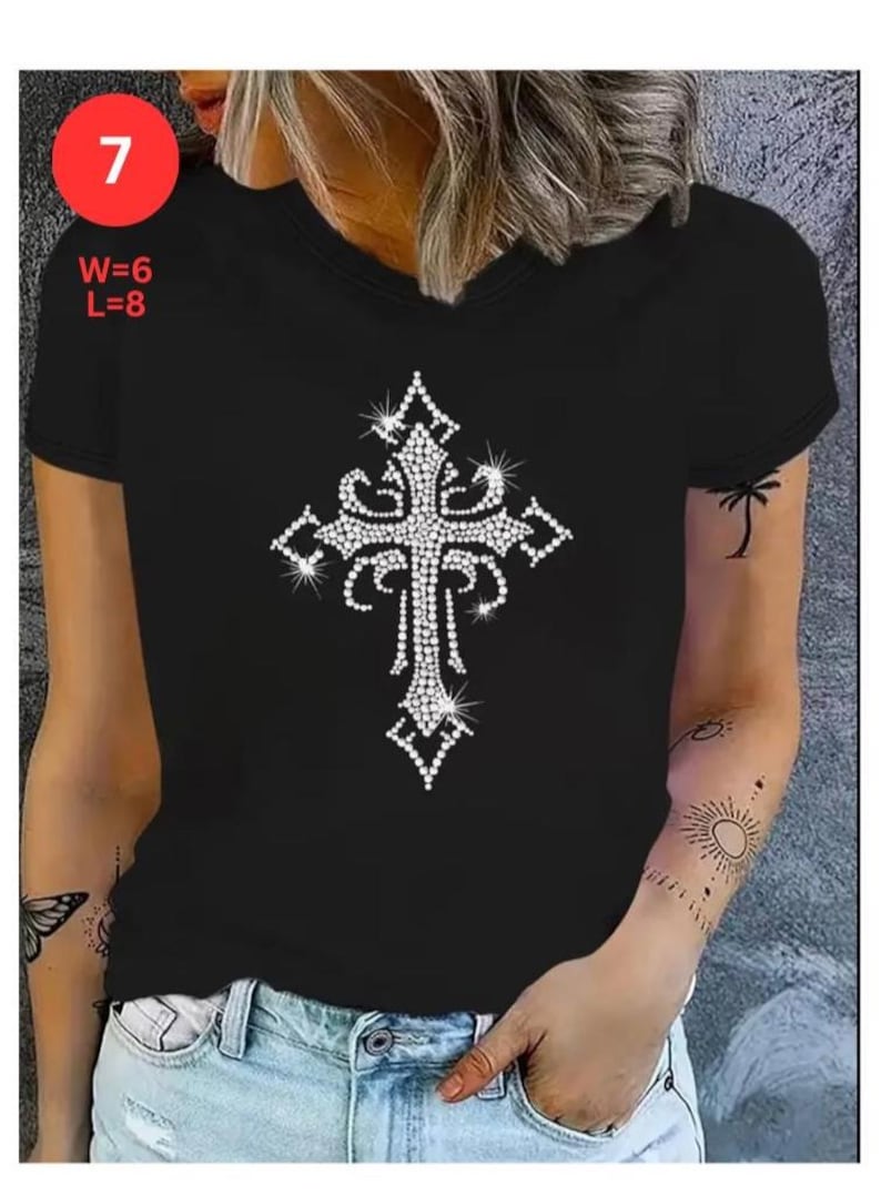 May include: Black V-neck t-shirt featuring a sparkling, rhinestone-studded cross design. The cross is the focal point, with intricate detailing. The shirt has a classic fit and short sleeves. The image also shows the text "W=6 L=8" and the number "7".
